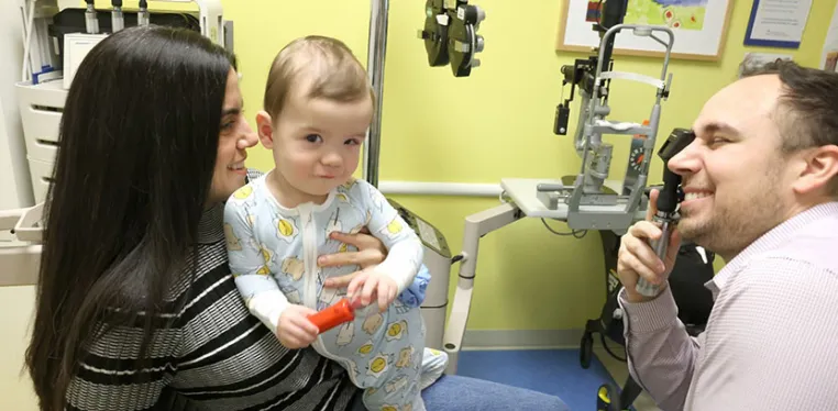 Pediatric ophthalmologist David Ramirez, MD, examines a young patient