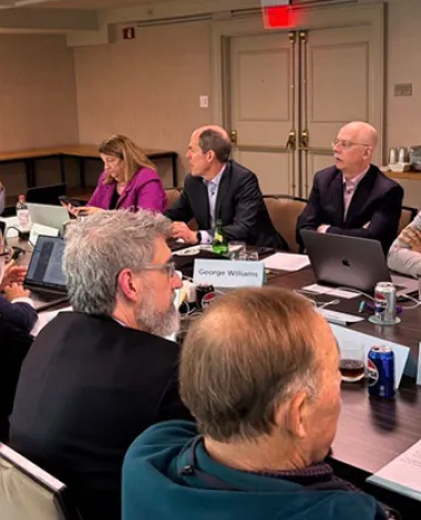 Members of the Academy Health Policy Committee sit at a conference table