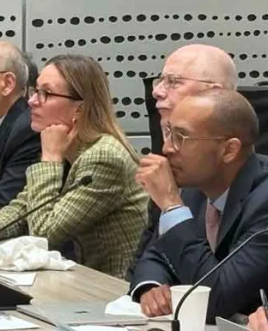 Academy Leadership sits at a large table with microphones