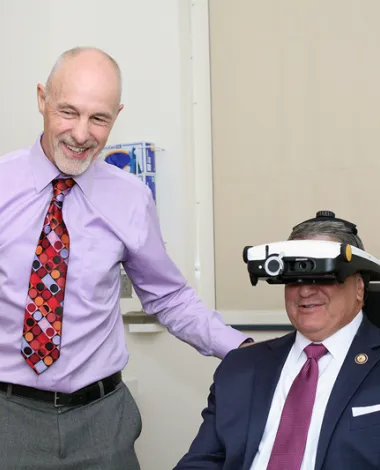 An ophthalmologist examines a policymaker during an August recess visit