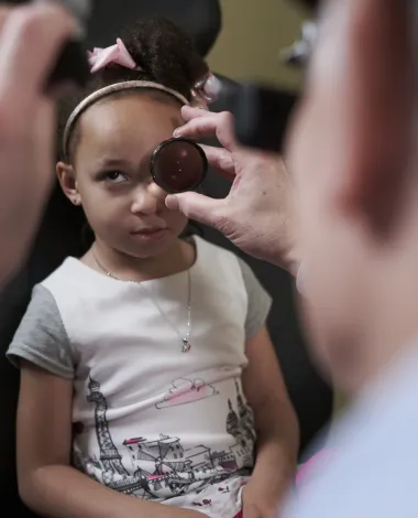 Ophthalmologist Stephen Lipsky, MD, examines a patient