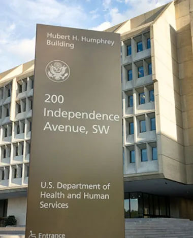 An exterior shot of a building with a sign that reads "Hubert H. Humphrey Building, 200 Independence Avenue, SW, U.S. Department of Health and Human Services"