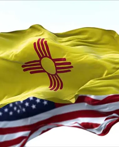 The New Mexico and United States flags fly side by side