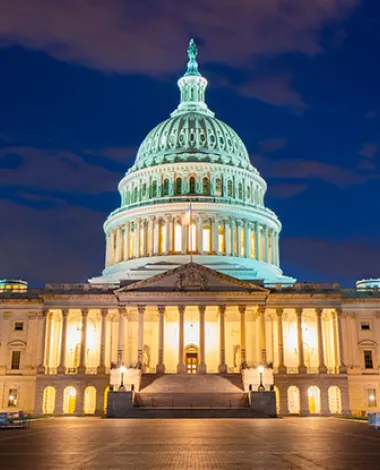 The US Capitol building lit at night