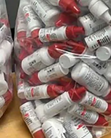 Plastic bags full of medical waste bottles