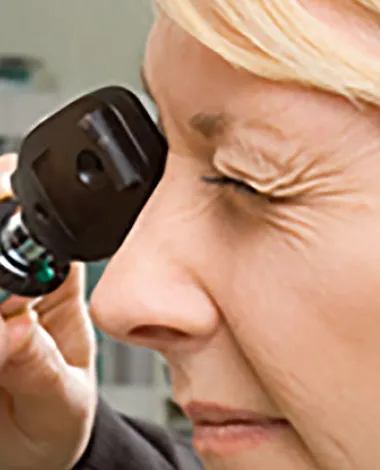 An ophthalmologist examines a patient's eye
