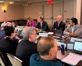 Members of the Academy Health Policy Committee sit at a conference table