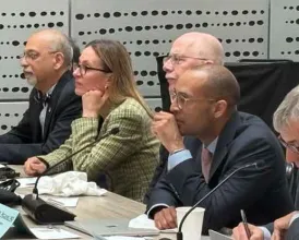 Academy Leadership sits at a large table with microphones