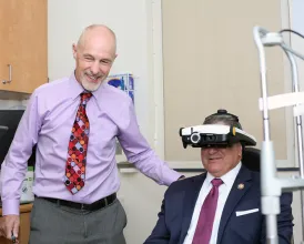 An ophthalmologist examines a policymaker during an August recess visit