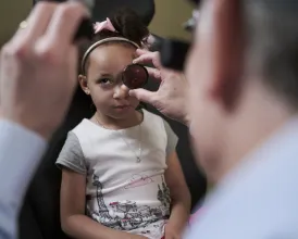 Ophthalmologist Stephen Lipsky, MD, examines a patient
