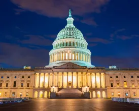 The US Capitol building lit at night