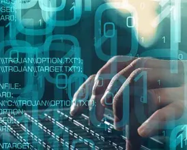 Hands typing on a keyboard overlaid with computer code