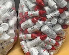 Plastic bags full of medical waste bottles